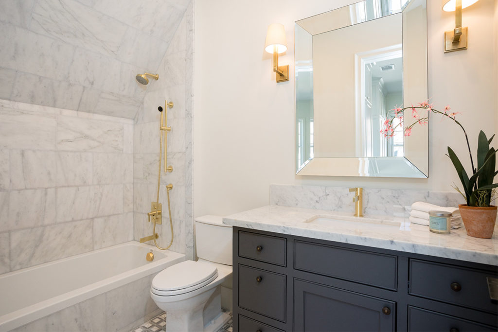 custom home secondary bath with Carrera marble counter-tops