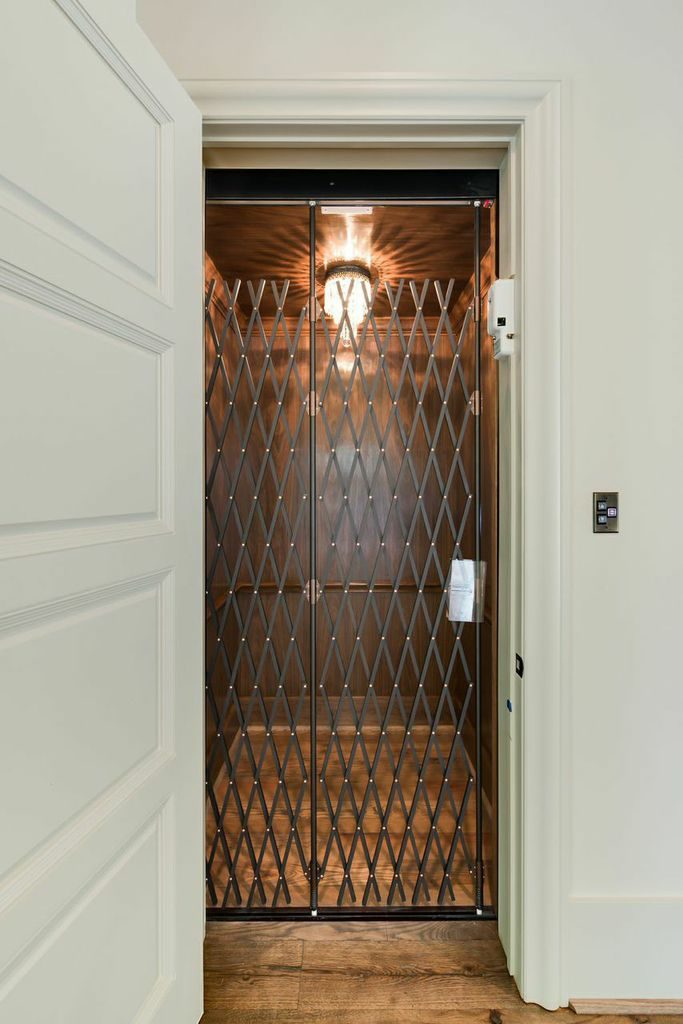 custom personal elevator with walnut paneling