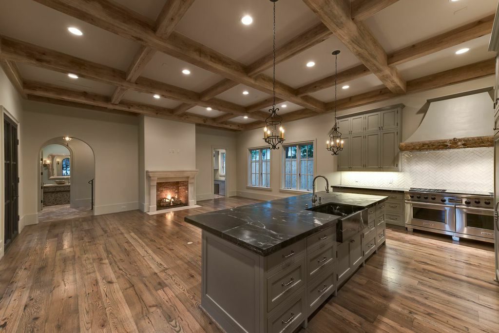 large custom great room with over-sized island and fireplace